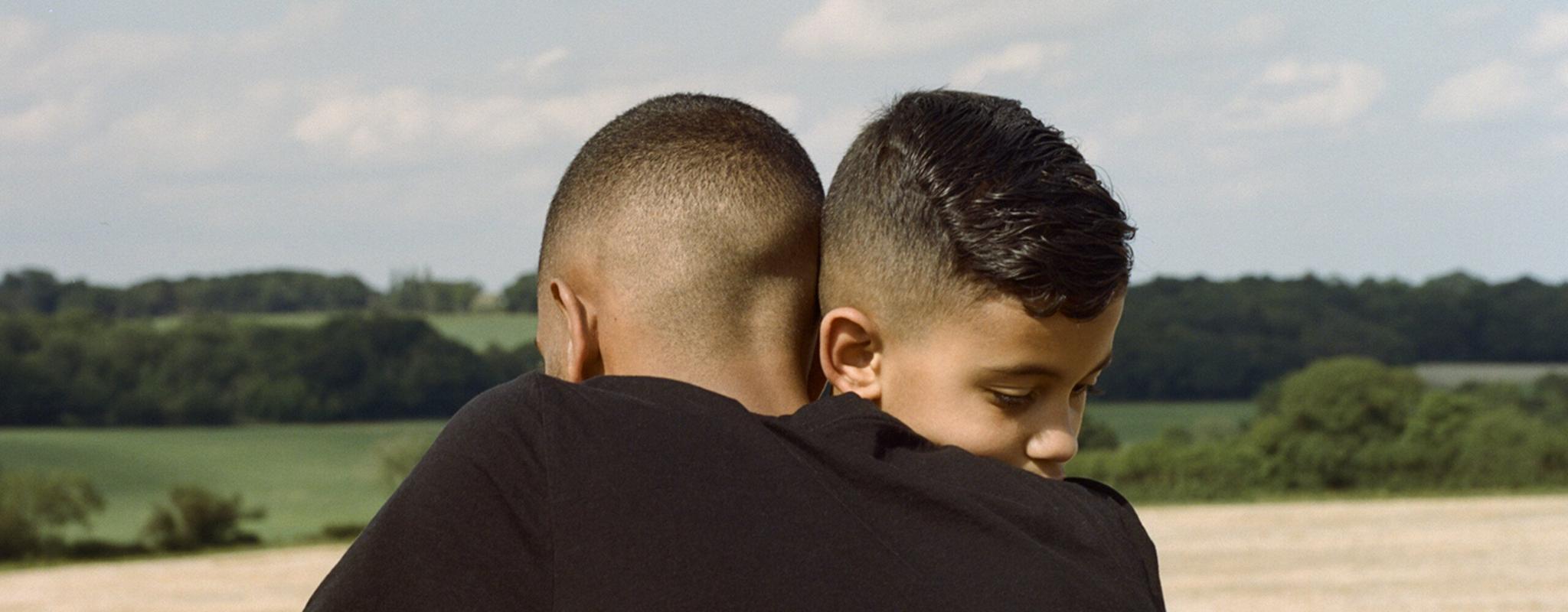 Two brothers hug in a park a few days after lockdown restrictions were eased.