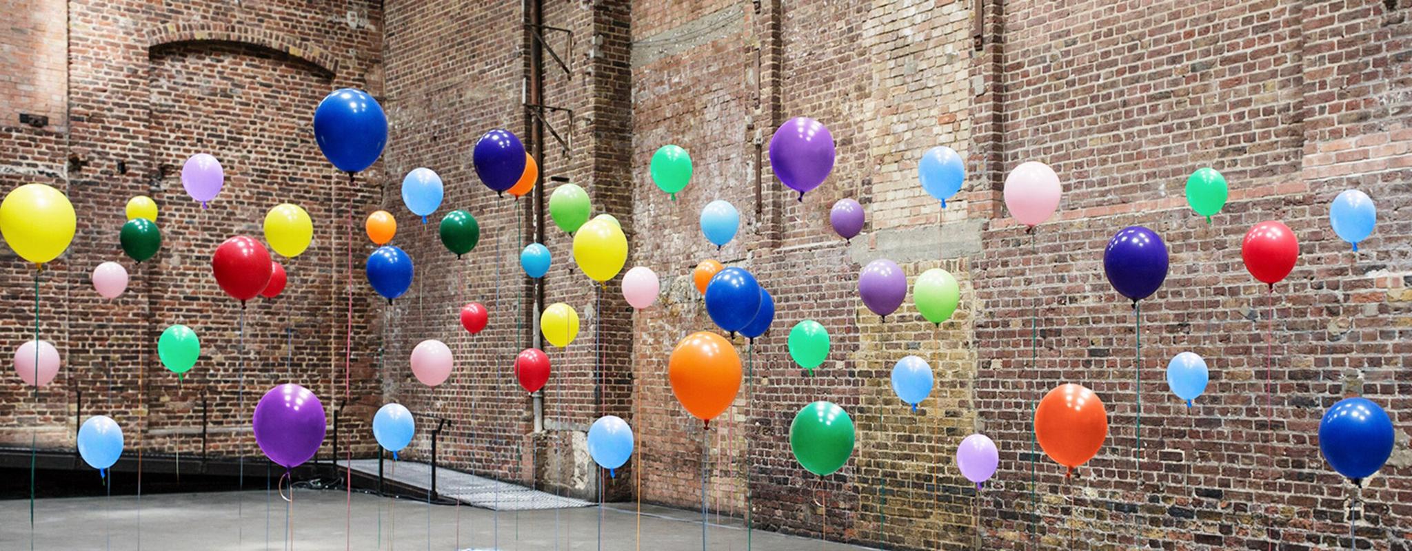 Colourful balloons in empty warehouse 
