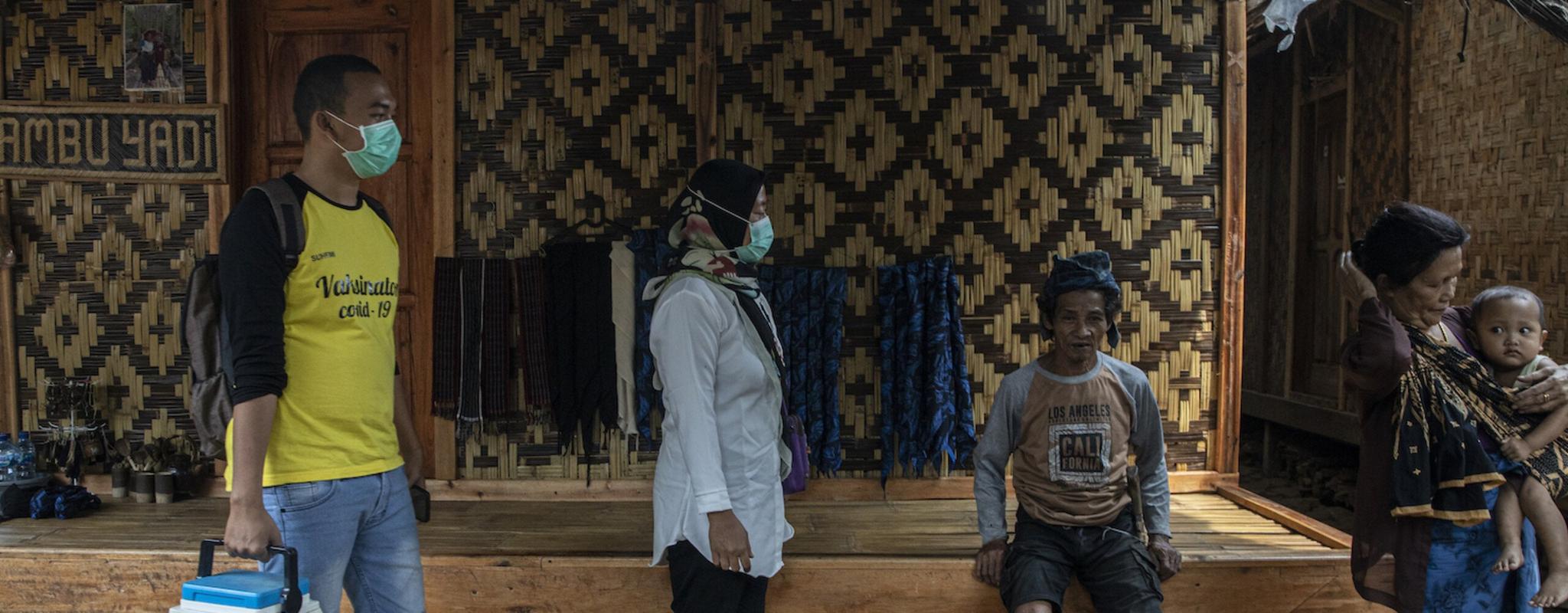 Vaccine facilitators in Indonesia try to persuade Baduy indigenous people to meet at their house during Covid-19. 