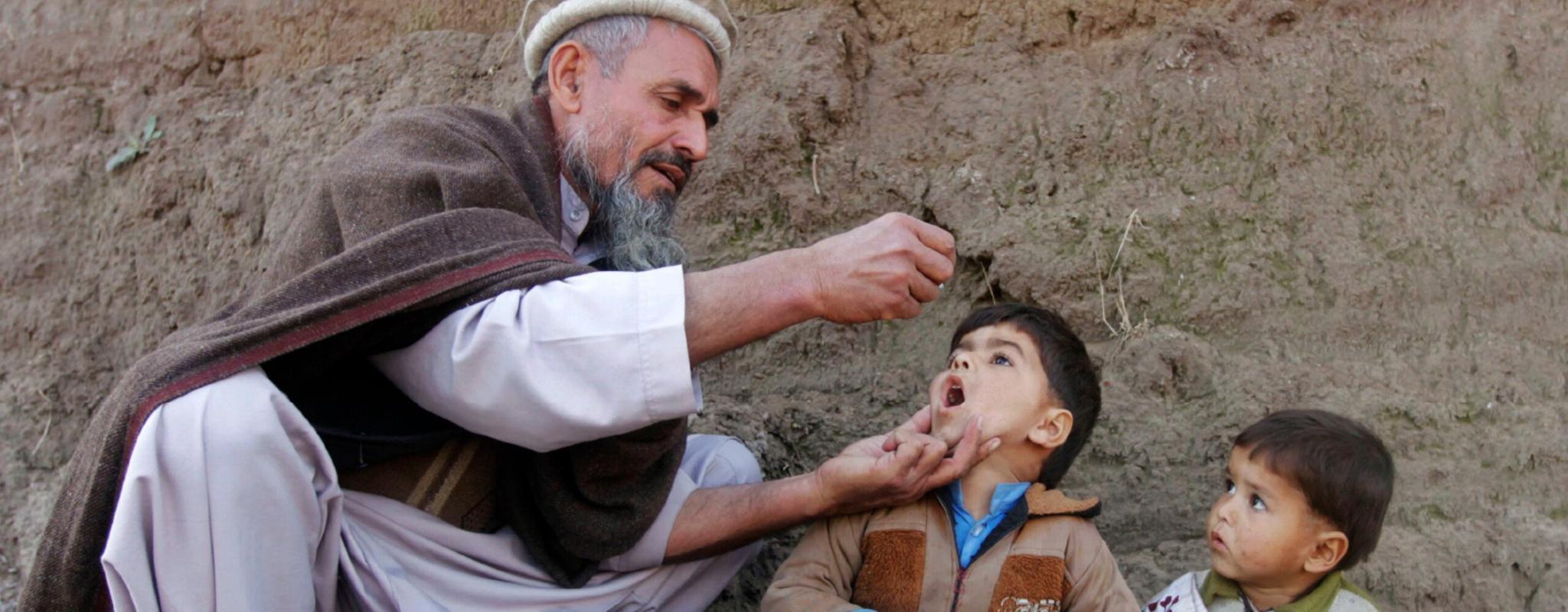 A child receives the polio vaccination during an anti-polio campaign on the outskirts of Jalalabad, Afghanistan