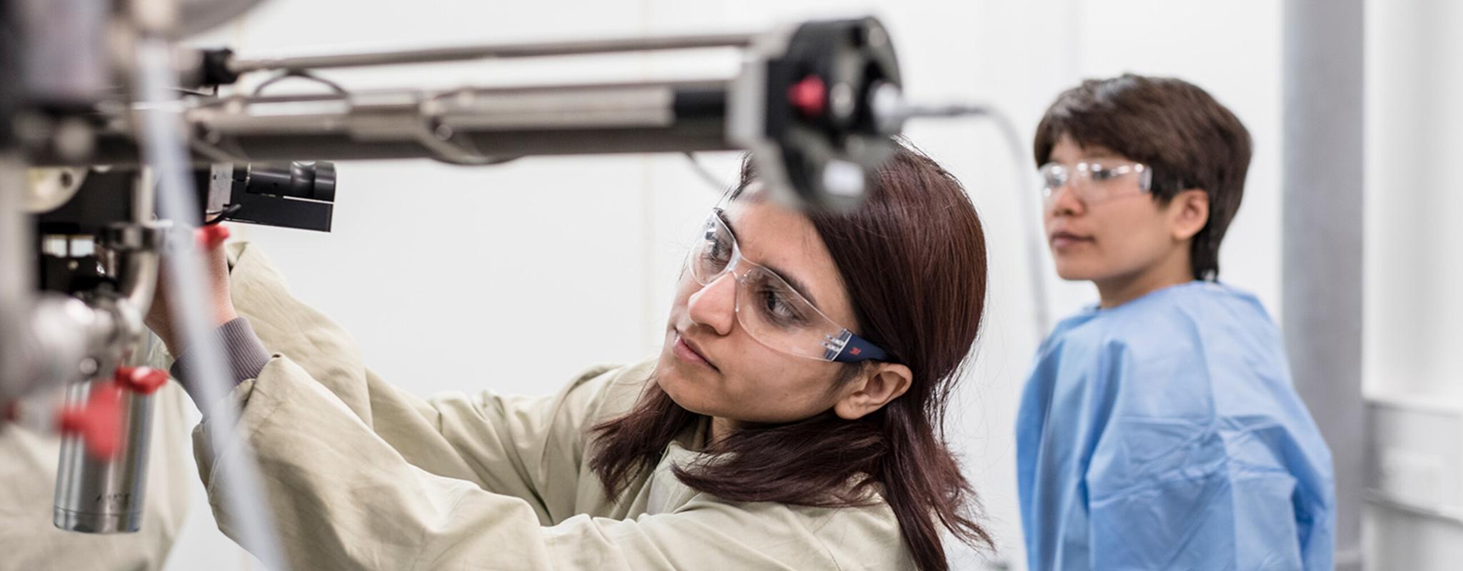 Woman scientist adjusting equipment in lab