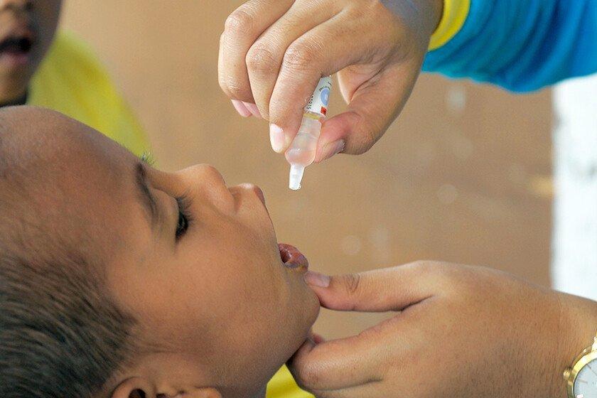 A child receiving oral polio drops 