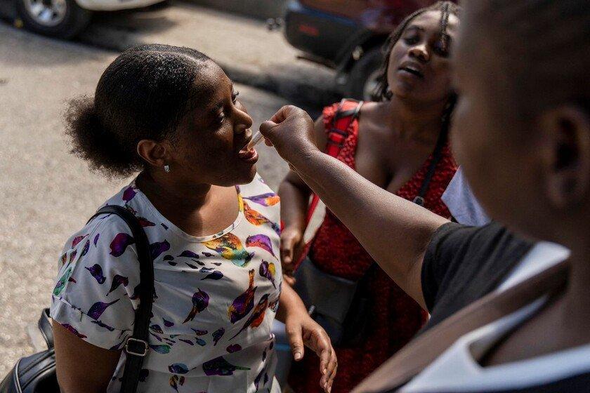 A woman receives an oral cholera vaccine.
