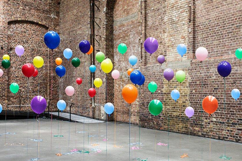 Colourful balloons in empty warehouse (Image © Anthony Harvie/Getty Images)