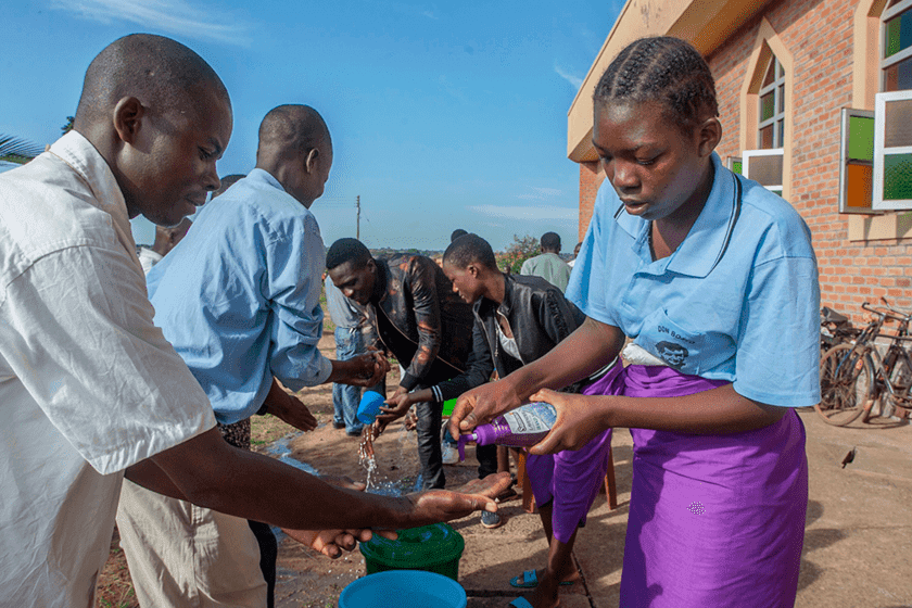 Five parishoners in Malawi wash their hands as a preventive measure against the spread of COVID-19