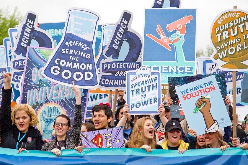 People on a demo in America holding placards supporting science