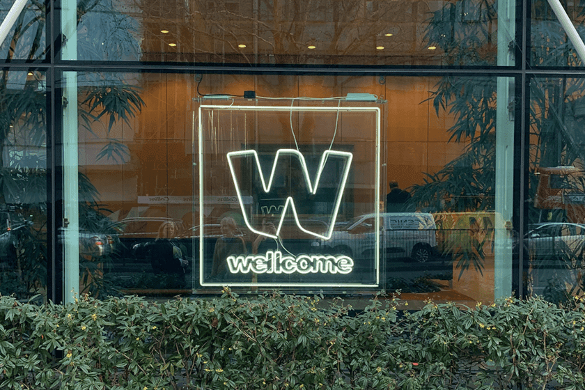 Neon Wellcome logo in window
