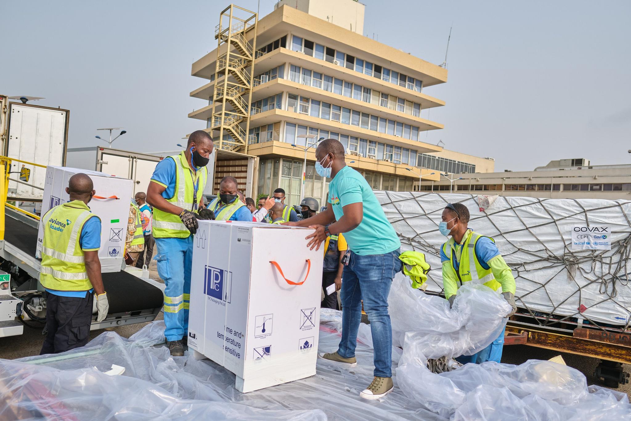 Men unload a delivery of Covid-19 vaccines in Ghana, West Africa