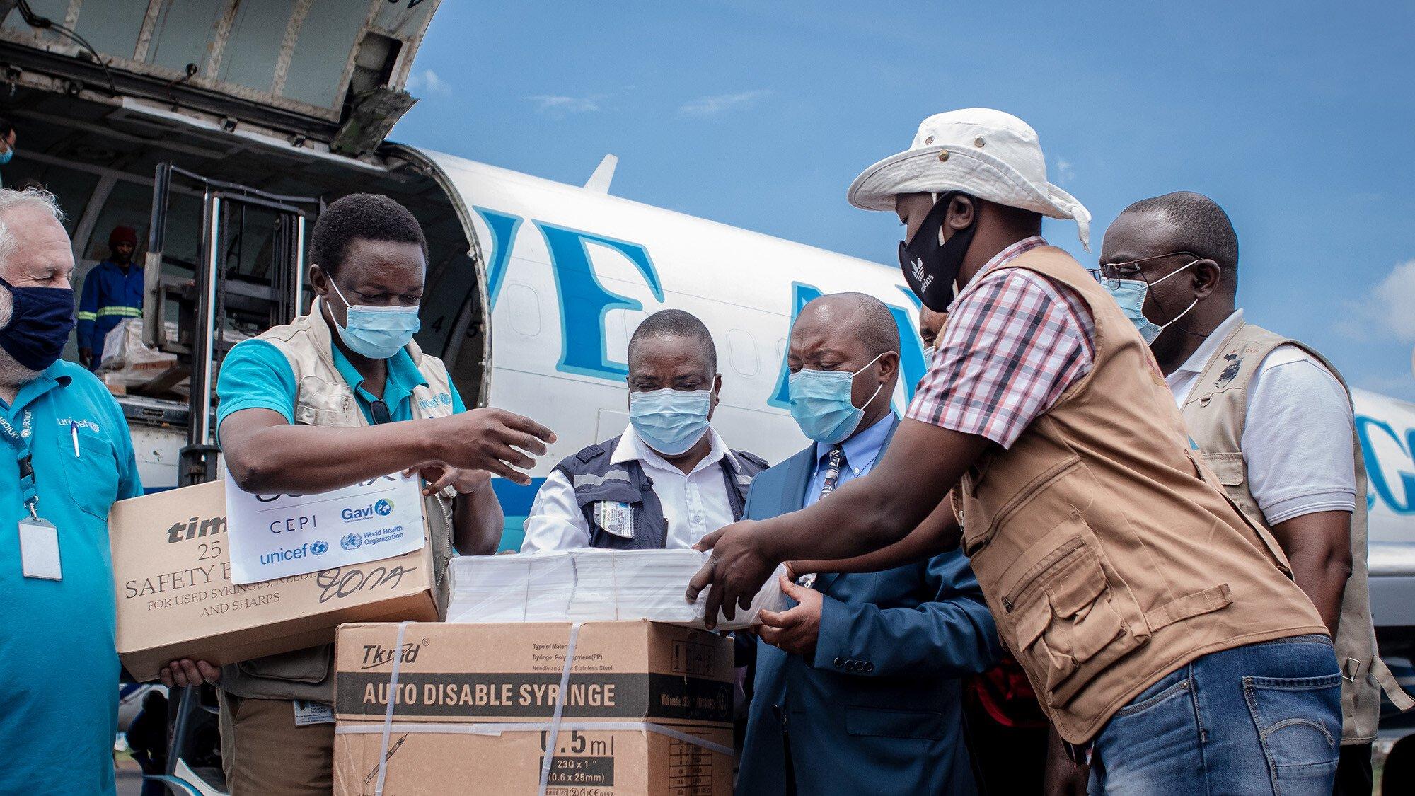 Airport staff and health personnel handle doses of Covid-19 vaccine during the arrival of a new batch at Goma International Airport, Democratic Republic of Congo.
