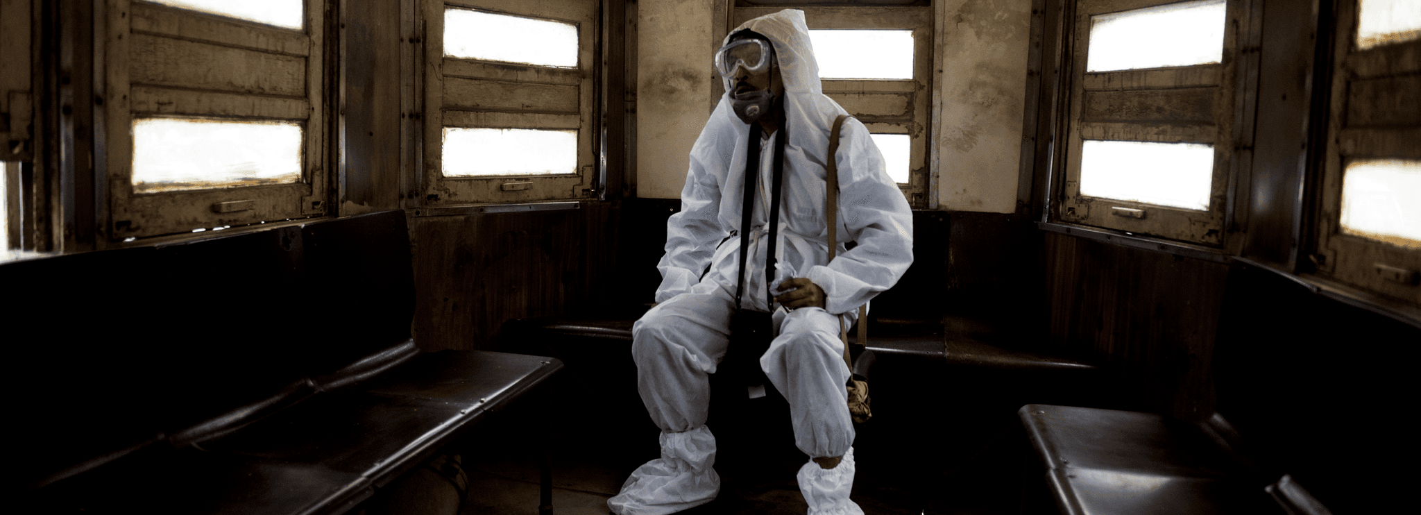 A tram conductor in Kolkata, India, wears protective clothing from head to toe in the heat of a summer afternoon, during the Covid-19 pandemic. 