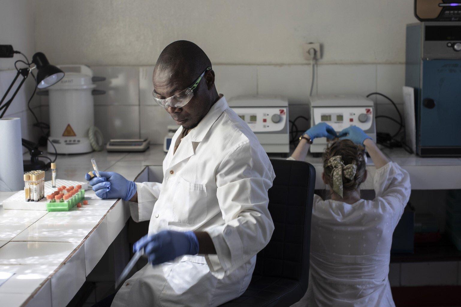 A healthcare worker analyses samples in a hospital laboratory.