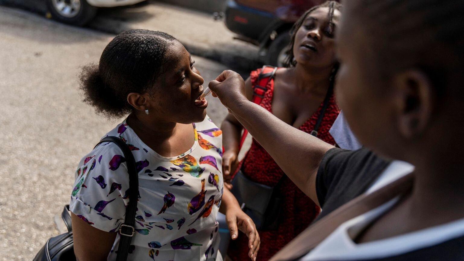A woman receives an oral cholera vaccine.