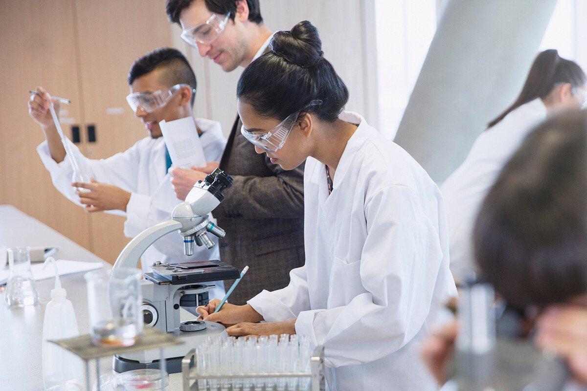 PhD students conducting scientific experiment in science laboratory classroom