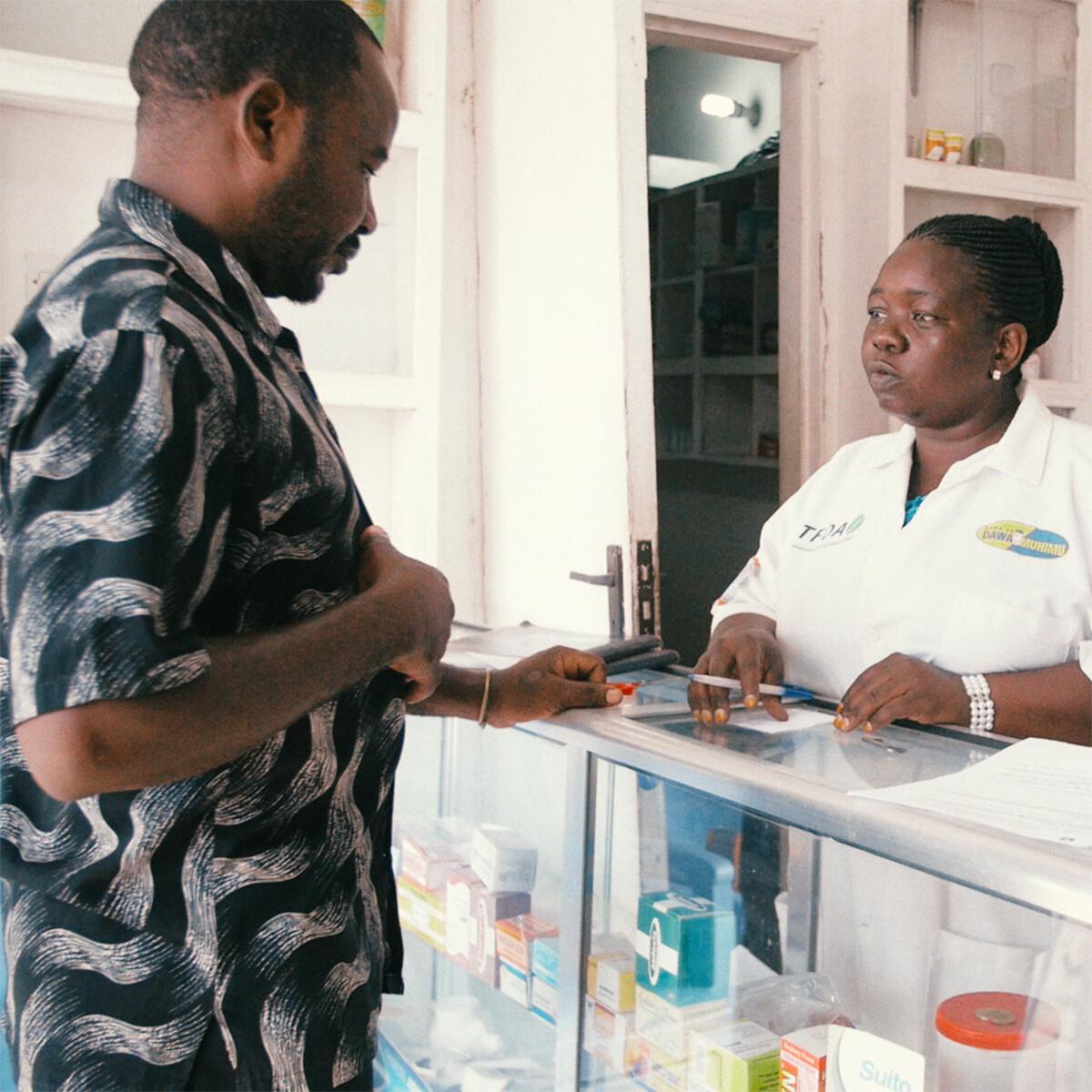 Customer and dispenser in a chemist's shop in Tanzania.